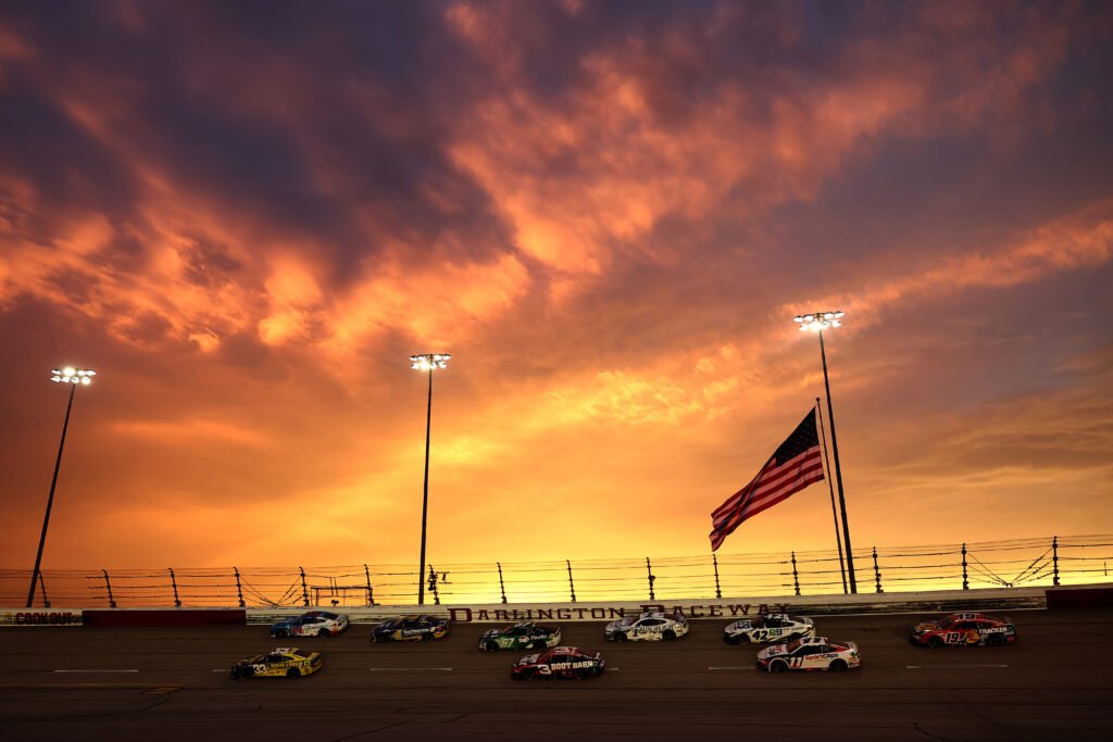 El pelotón de la NASCAR Cup marcha en el atardecer de Darlington